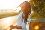 Young beautiful boho woman in summertime enjoying the sunset